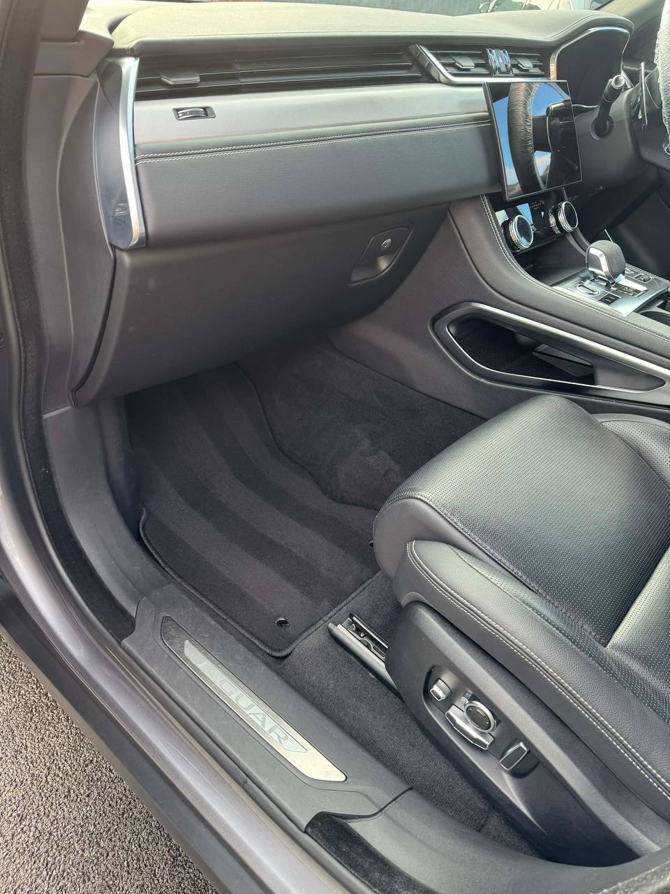 Jaguar interior with clean leather seats and footwell after an interior detail